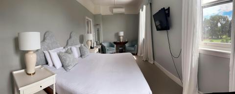 A wide shot of the room with the bed in the foreground.