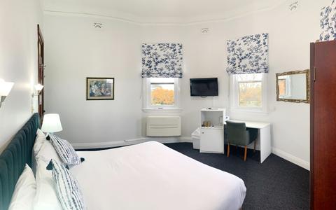 A shot from the side of the bed, with views outside