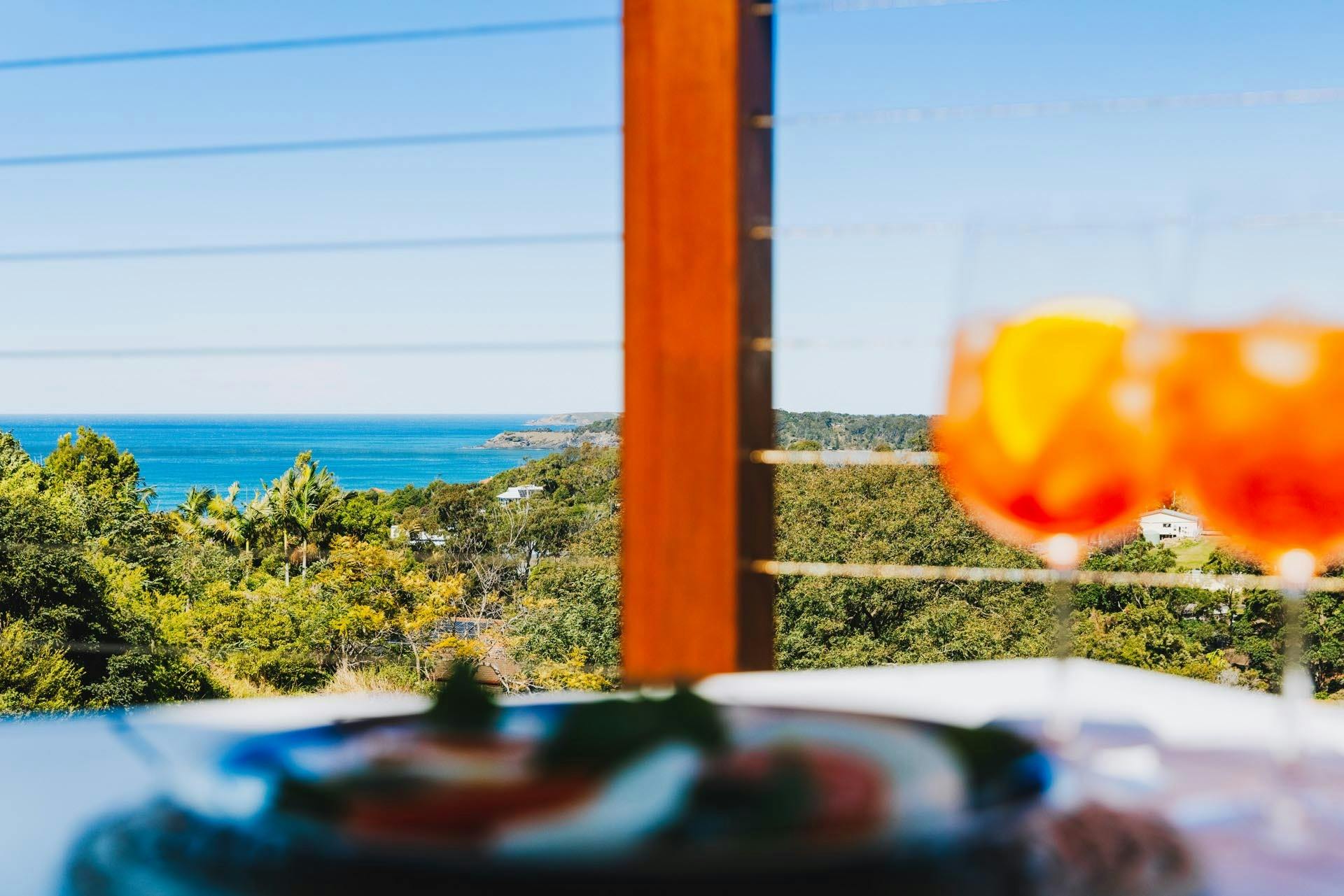 Relax at Ciao Korora with an Aperol Spritz and enjoy mountain and ocean views