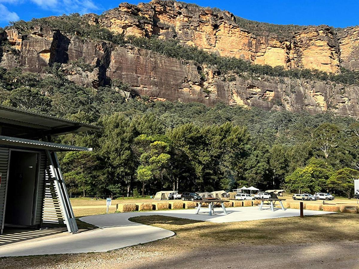 A concrete footpath leads directly from the 2 accessible campsites to the accessible toilet. Credit: