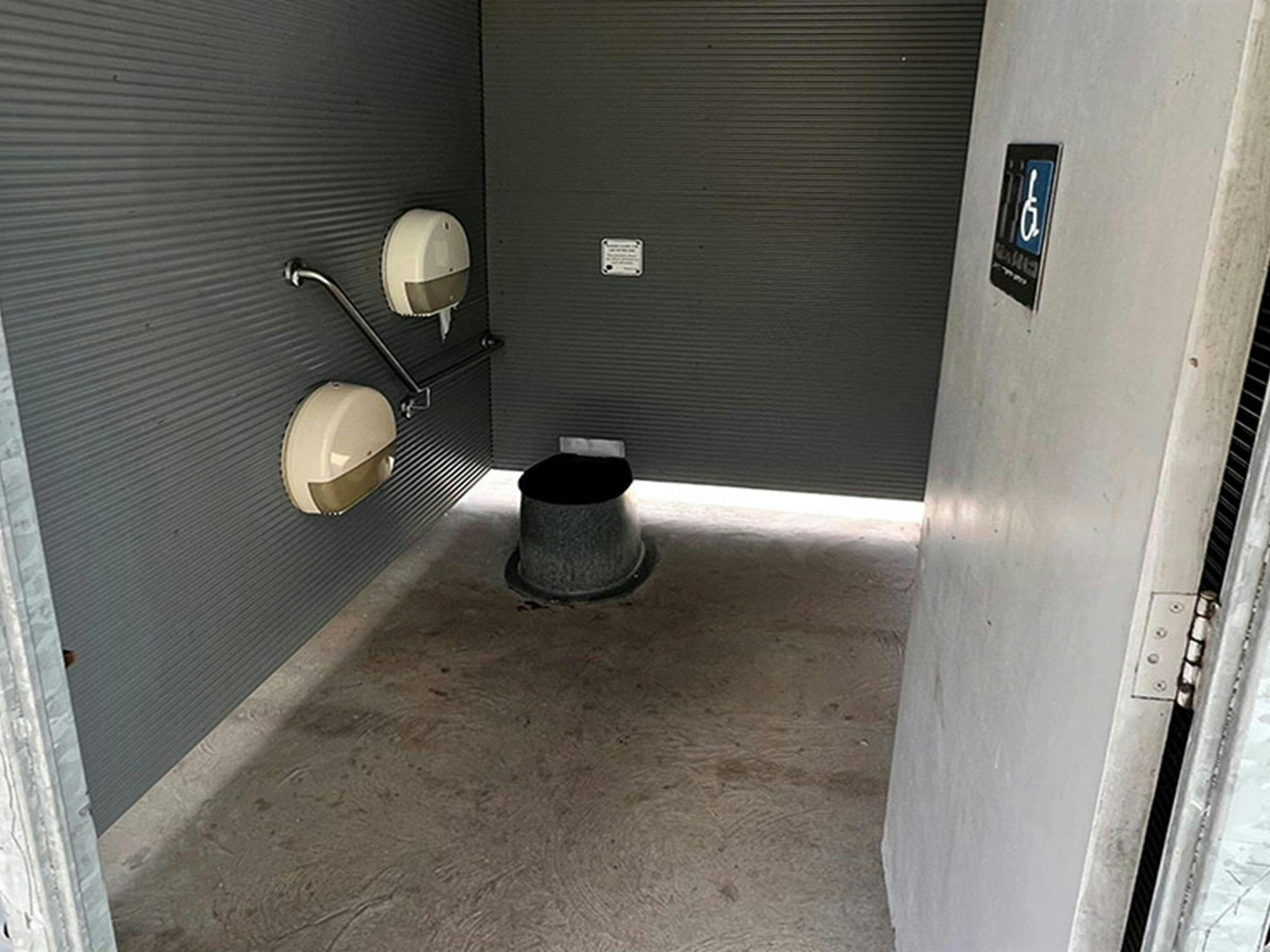 Interior view of the non-flush toilet with handrail at Coorongooba campground. Credit: &copy; DCCEEW