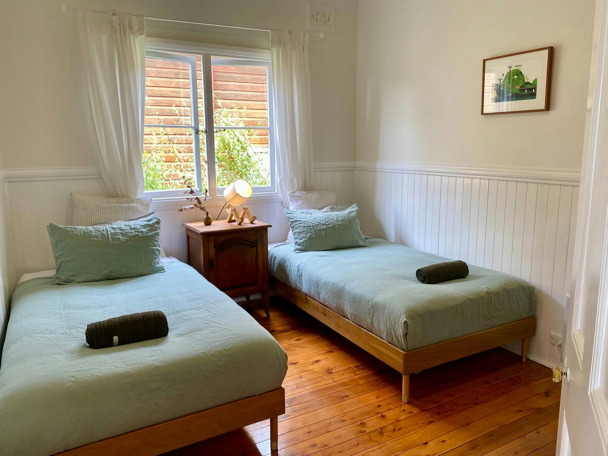 Two king singles, French flax linen, ceiling fan, and heating panels—perfect for extra guests.