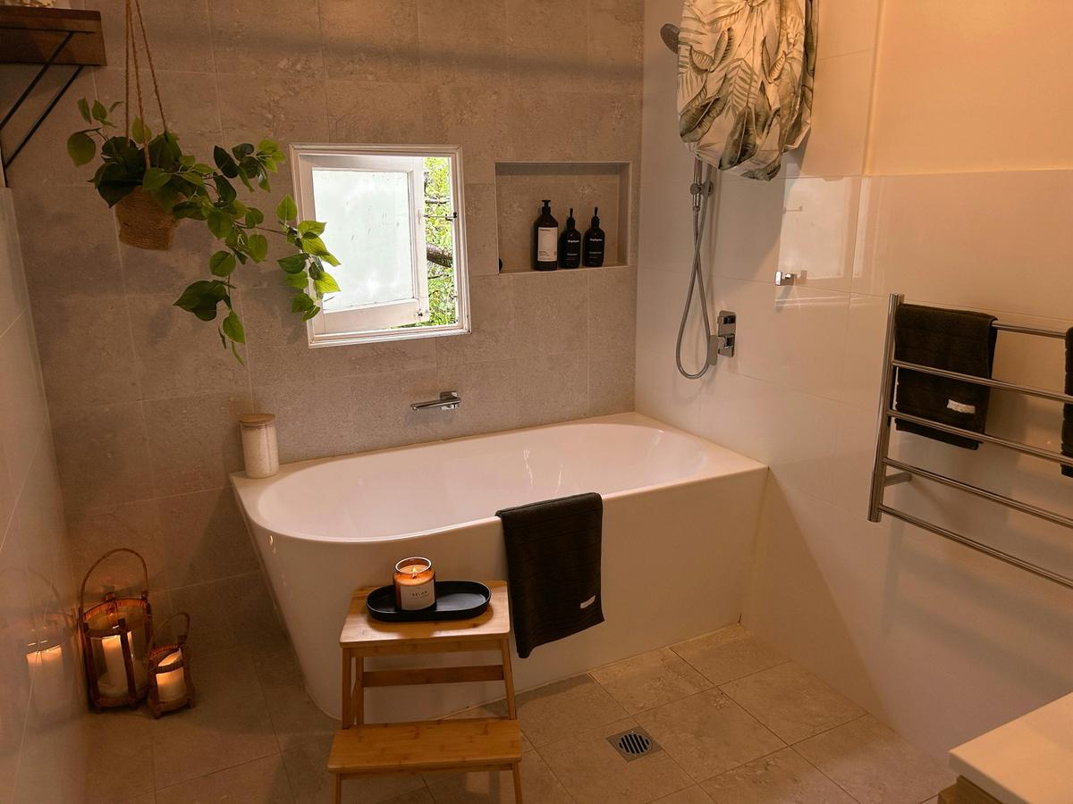 The bathroom has heated floors and towel racks, and a deep bath.