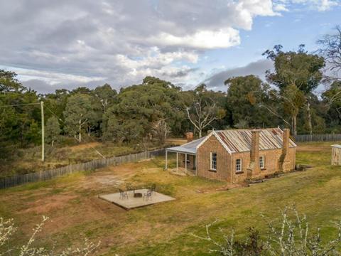 The exterior of Fairfax House, surrounded by trees in Hill End Historic Site. Photo: John Spencer
