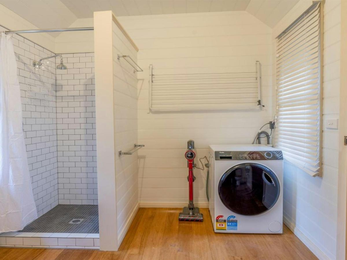 The external bathroom with shower and washing machine in Fairfax House, Hill End Historic Site.