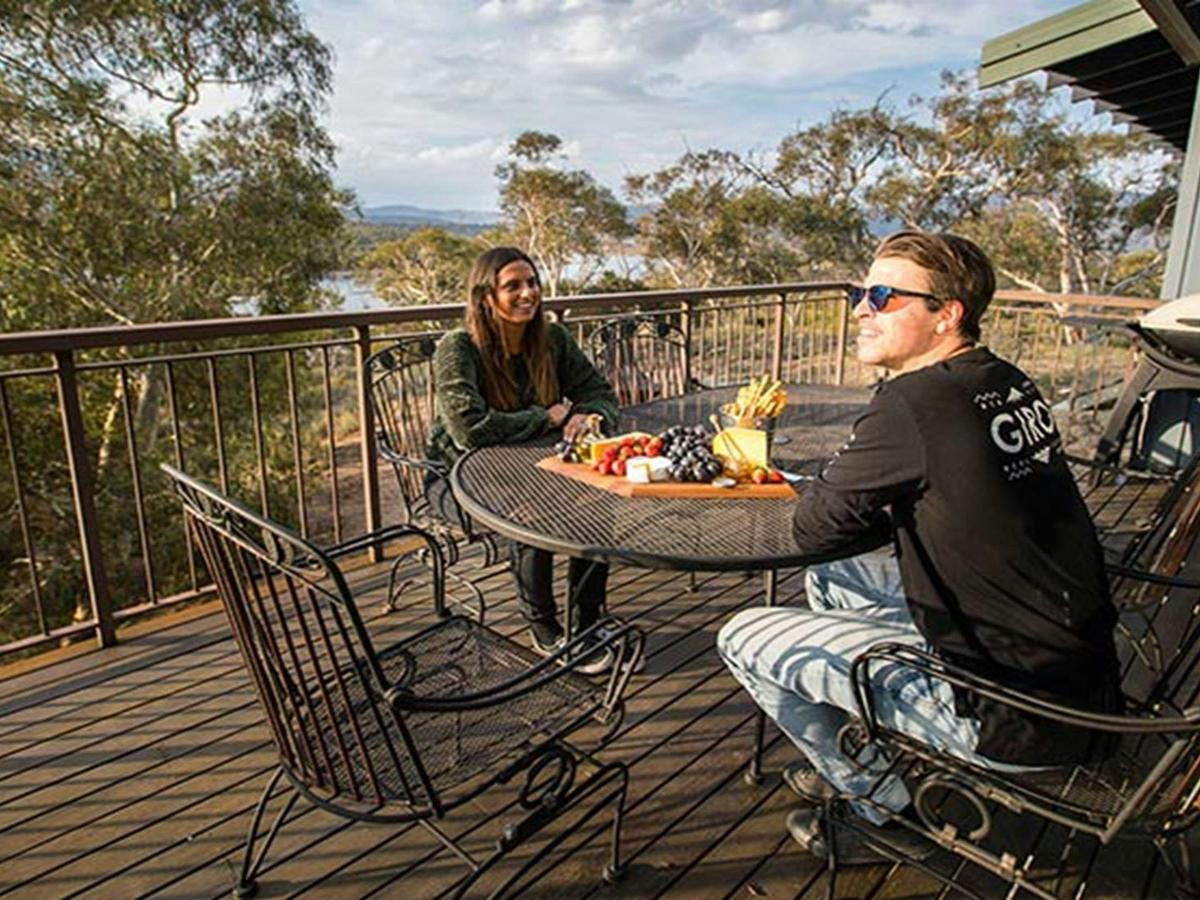 A couple relax on the balcony at Creel Lodge, Kosciuszko National Park. Photo: Boen Ferguson/OEH.
