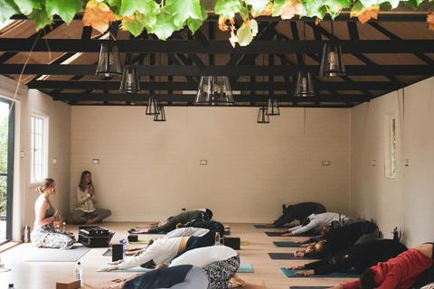 Retreat group practicing yoga in the barn