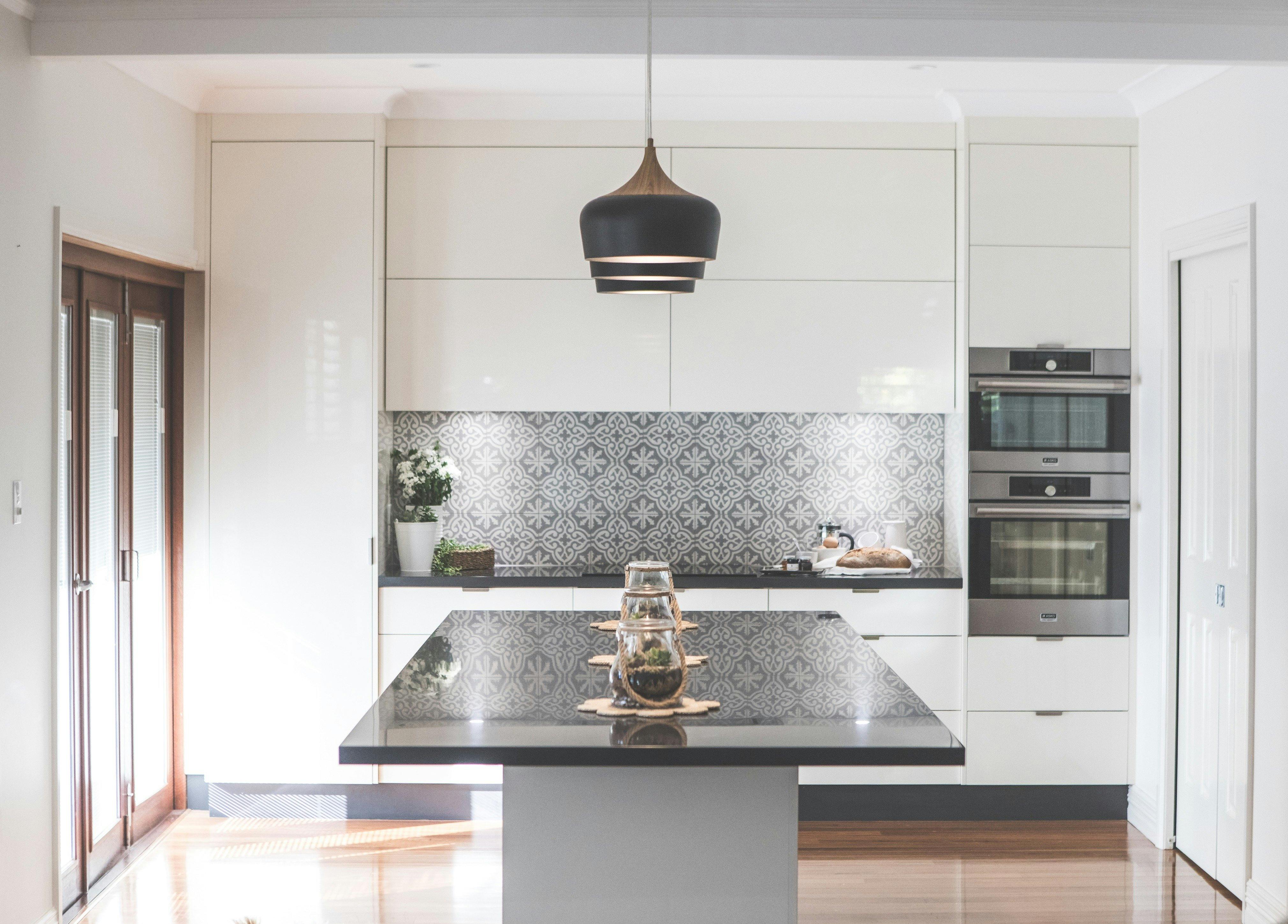 The kitchen area includes butlers pantry to the right and bi fold opening doors to garden area.