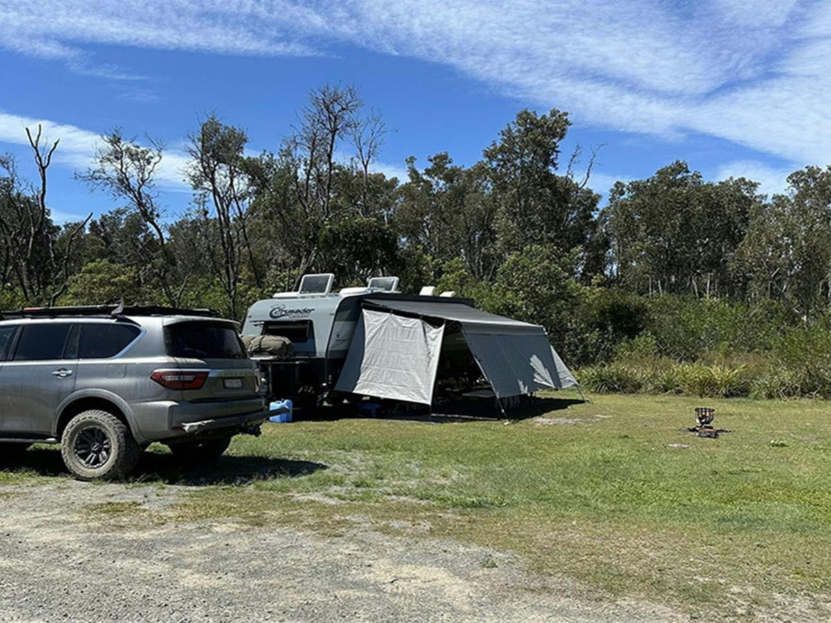 A tent setup next to vehicle at Crowdy Gap campground. Credit: &copy; DCCEEW