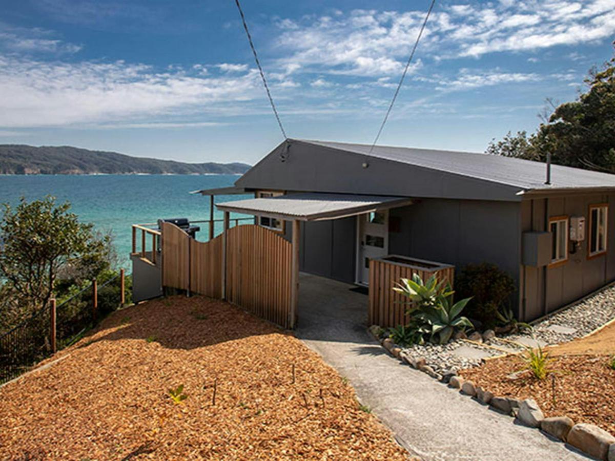 Pathway leading to Davies Cottage with Sugarloaf Bay in the background. Photo: John Spencer &copy;