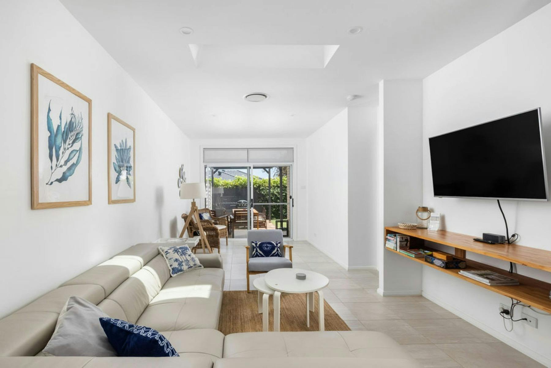 Open plan living area with leather lounge for a relaxing stay