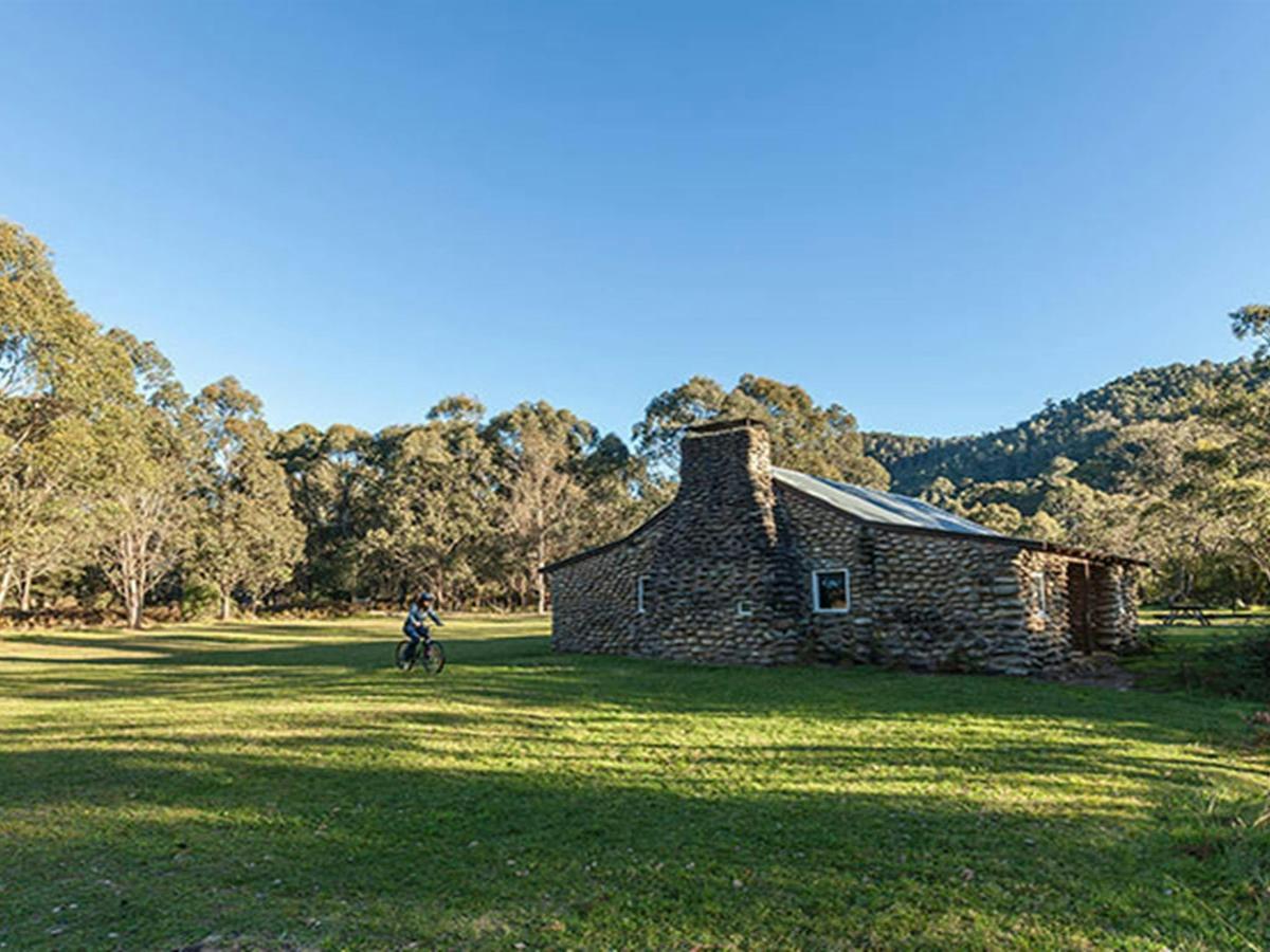 A cyclist rides past Geehi Hut, Kosciuszko National Park. Photo: Murray Vanderveer/OEH