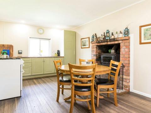 The dining table and kitchen at Four Bull Hut at Washpool National Park. Photo &copy; DPE