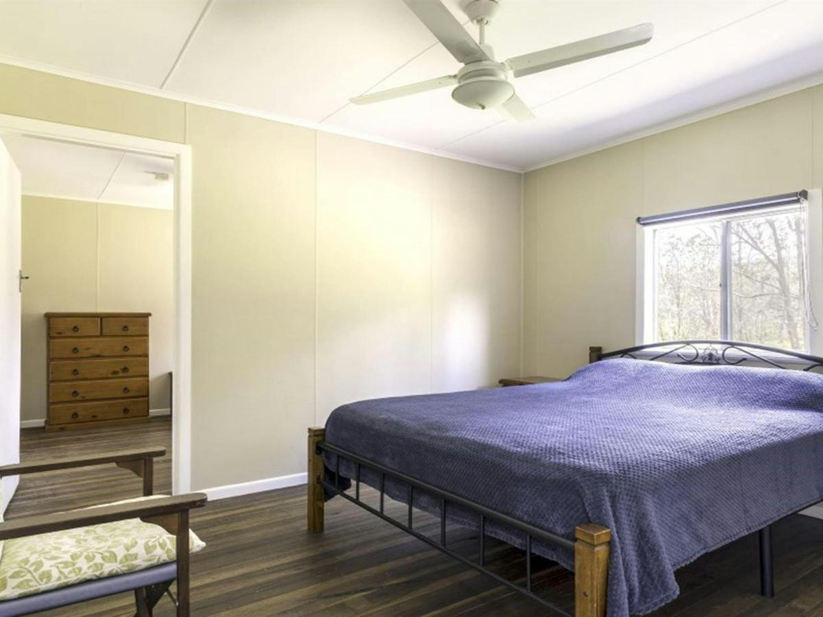 A bedroom with double bed at Four Bull Hut in Washpool National Park. Photo &copy; DPE