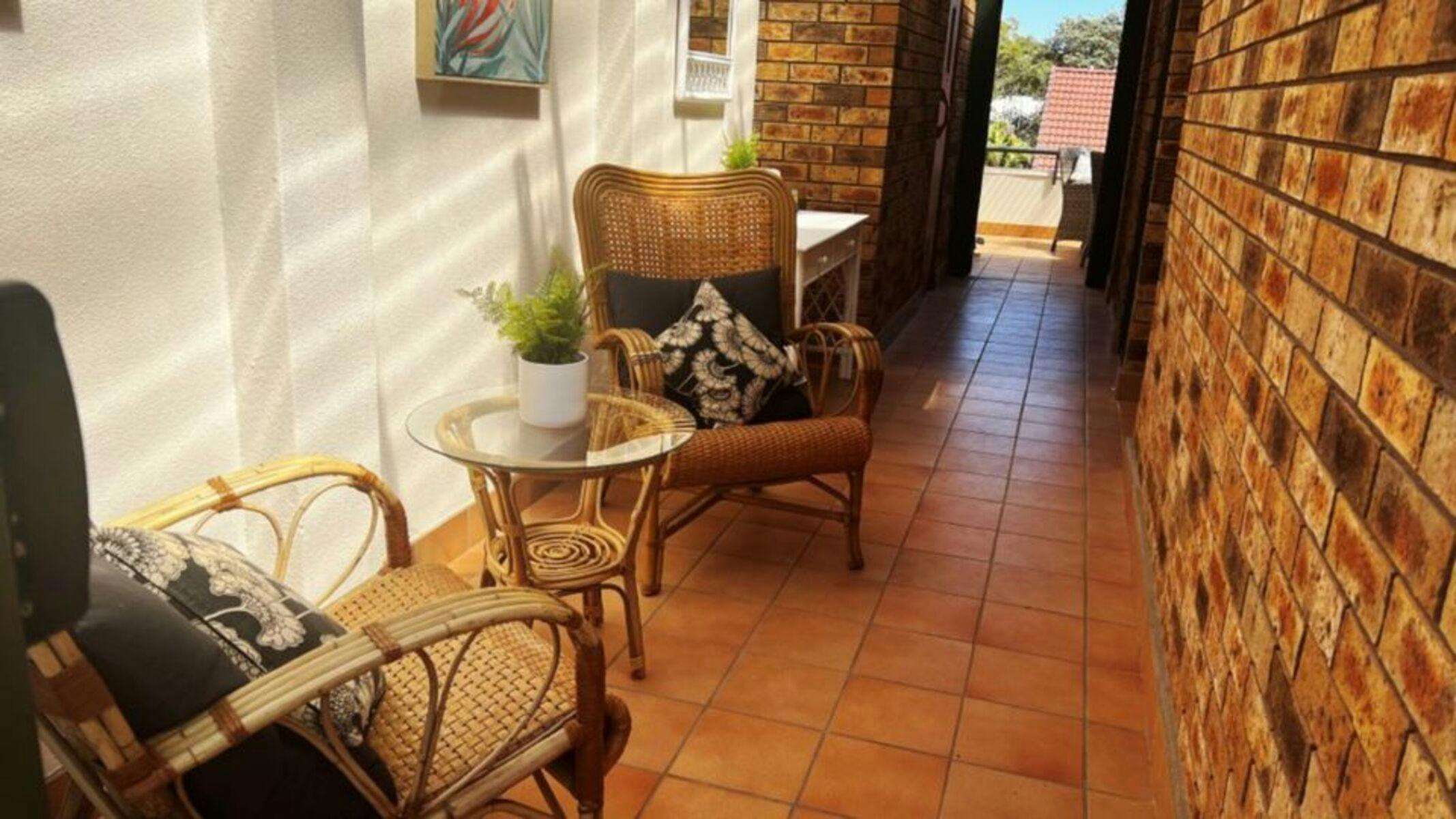 Atrium with cane chairs and side table
