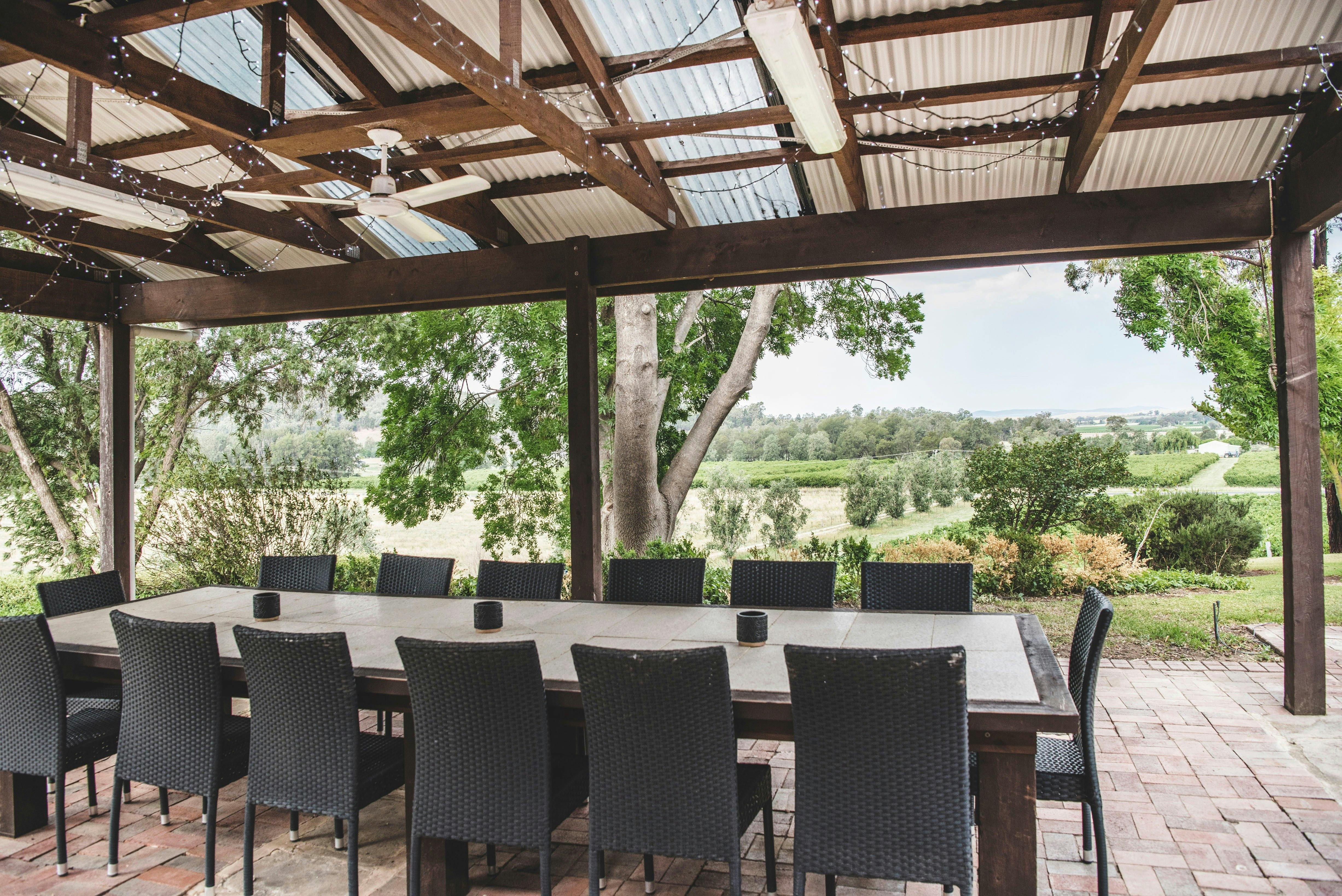 Outdoor dining area includes fire pit, wood fired pizza oven and barbecue