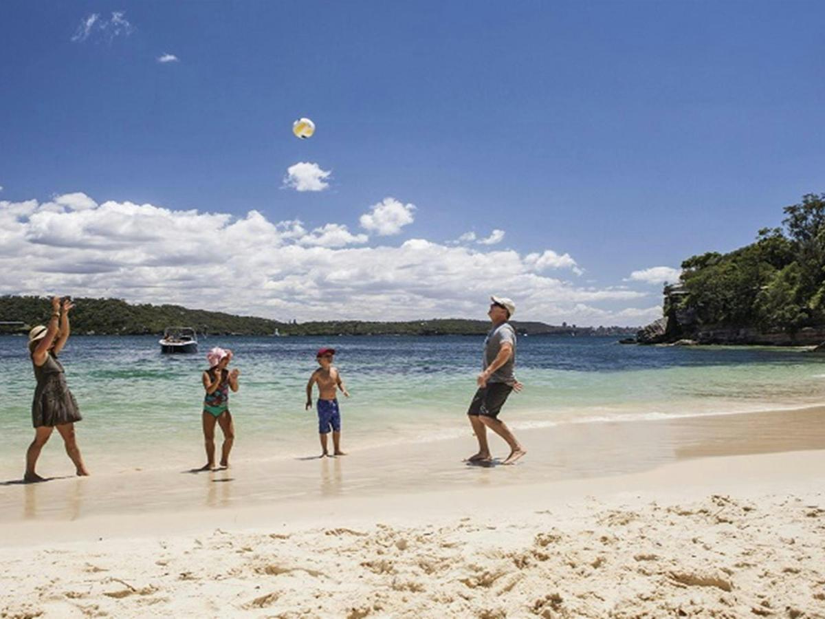 A family enjoying a day at Shark Beach, Sydney Harbour National Park. Photo: David Finnegan/DPIE