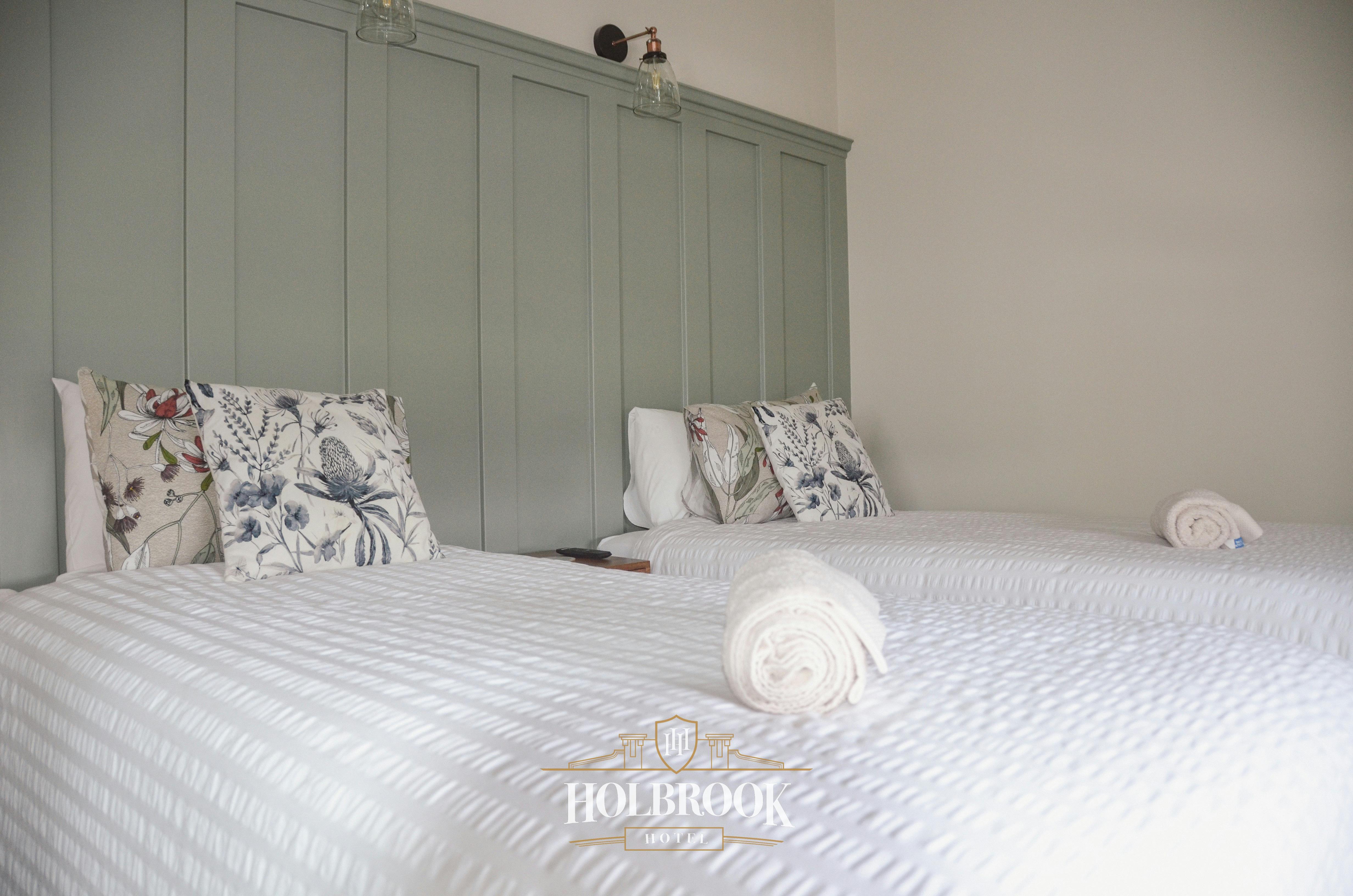 Twin Room with white sheets and green headboard