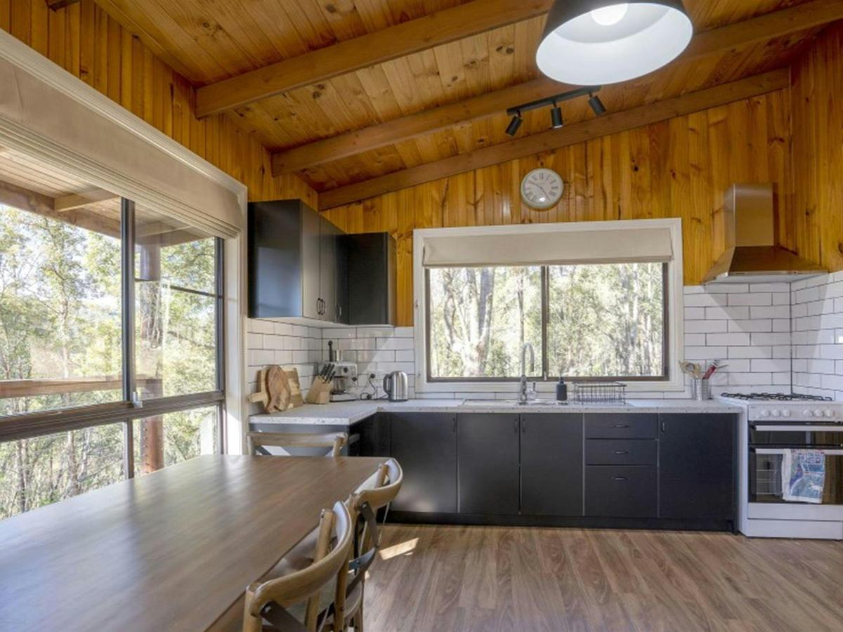The fully-furnished kitchen and dining table at Galong cabins. Photo: Simone Cottrell &copy; DPIE
