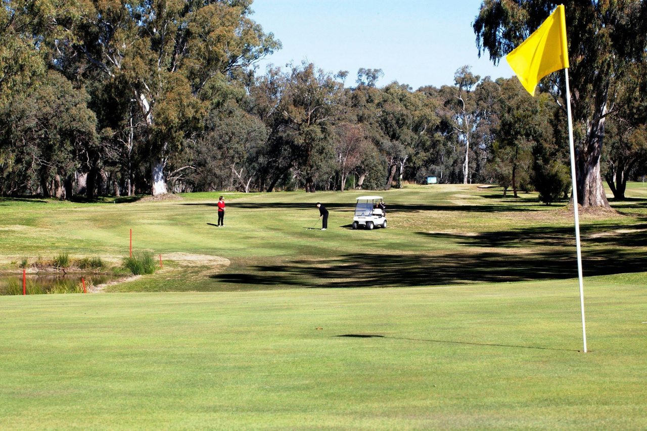 Chipping onto the 7th Green, with the state forest in the background.