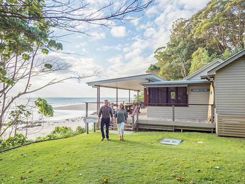 Couple walking on the lawn at Imeson Cottage. Photo: Sera Wright/DPIE.