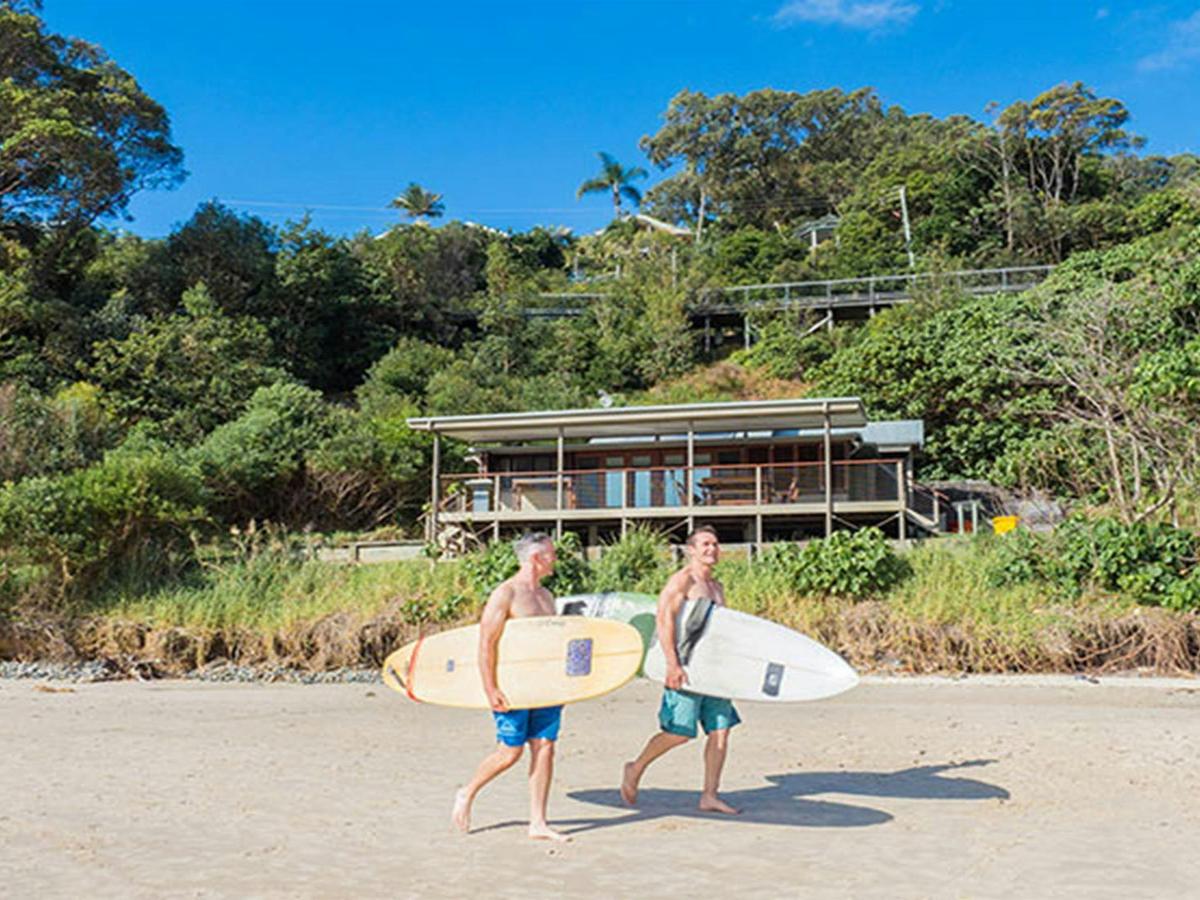 Friends with surfboards heading off to the beach. Photo: Sera Wright/DPIE.