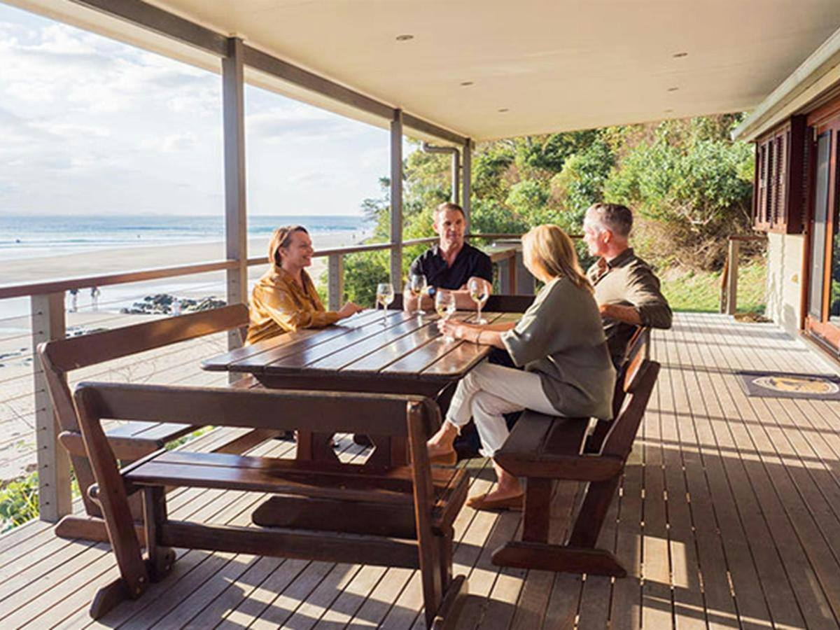 Friends drinking on the balcony of Imeson Cottage. Photo: Sera Wright/DPIE.