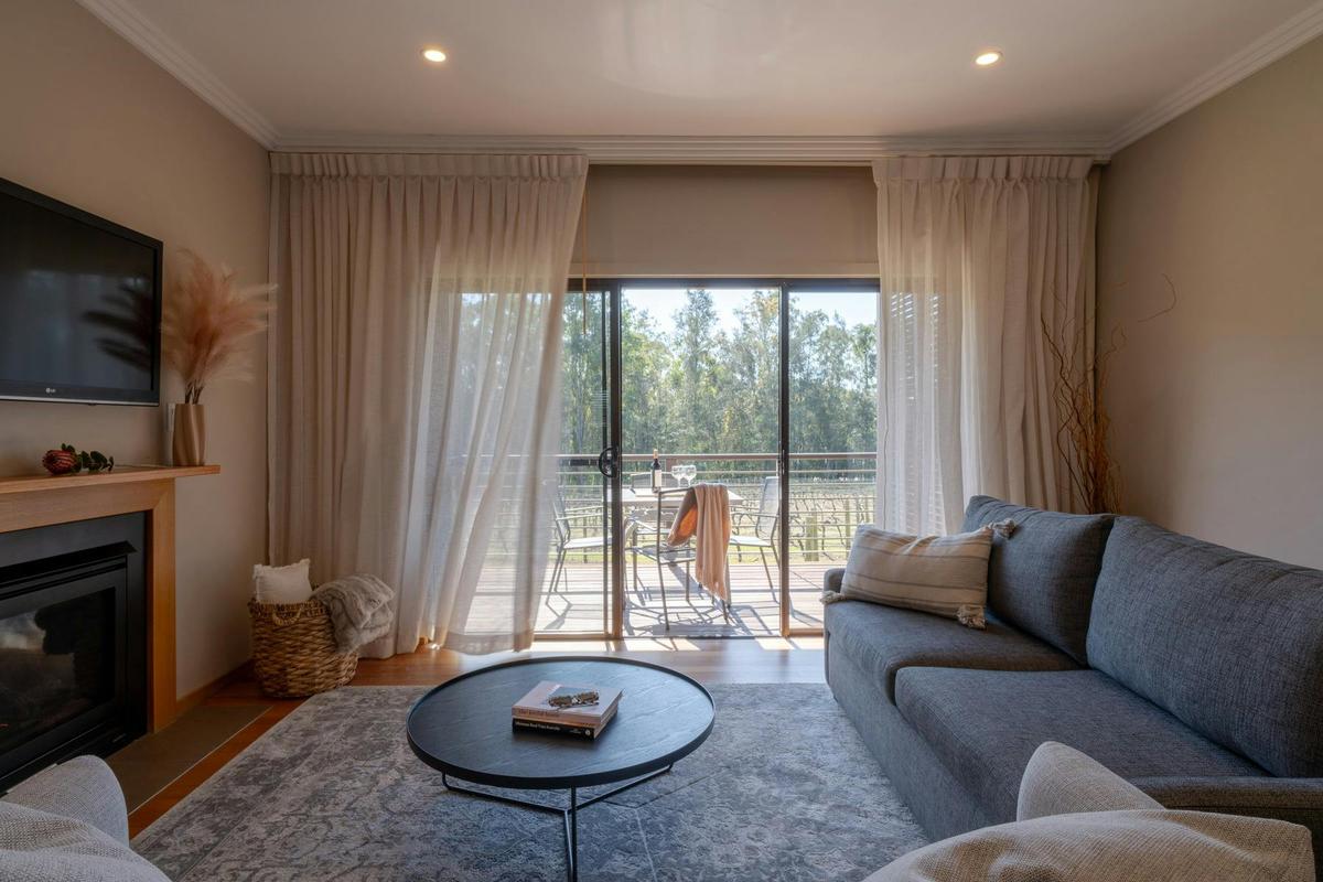 Premier Suite living room and balcony overlooking our on site vineyard