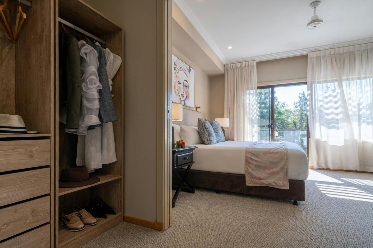 Premier Suite master bedroom and walk in robe