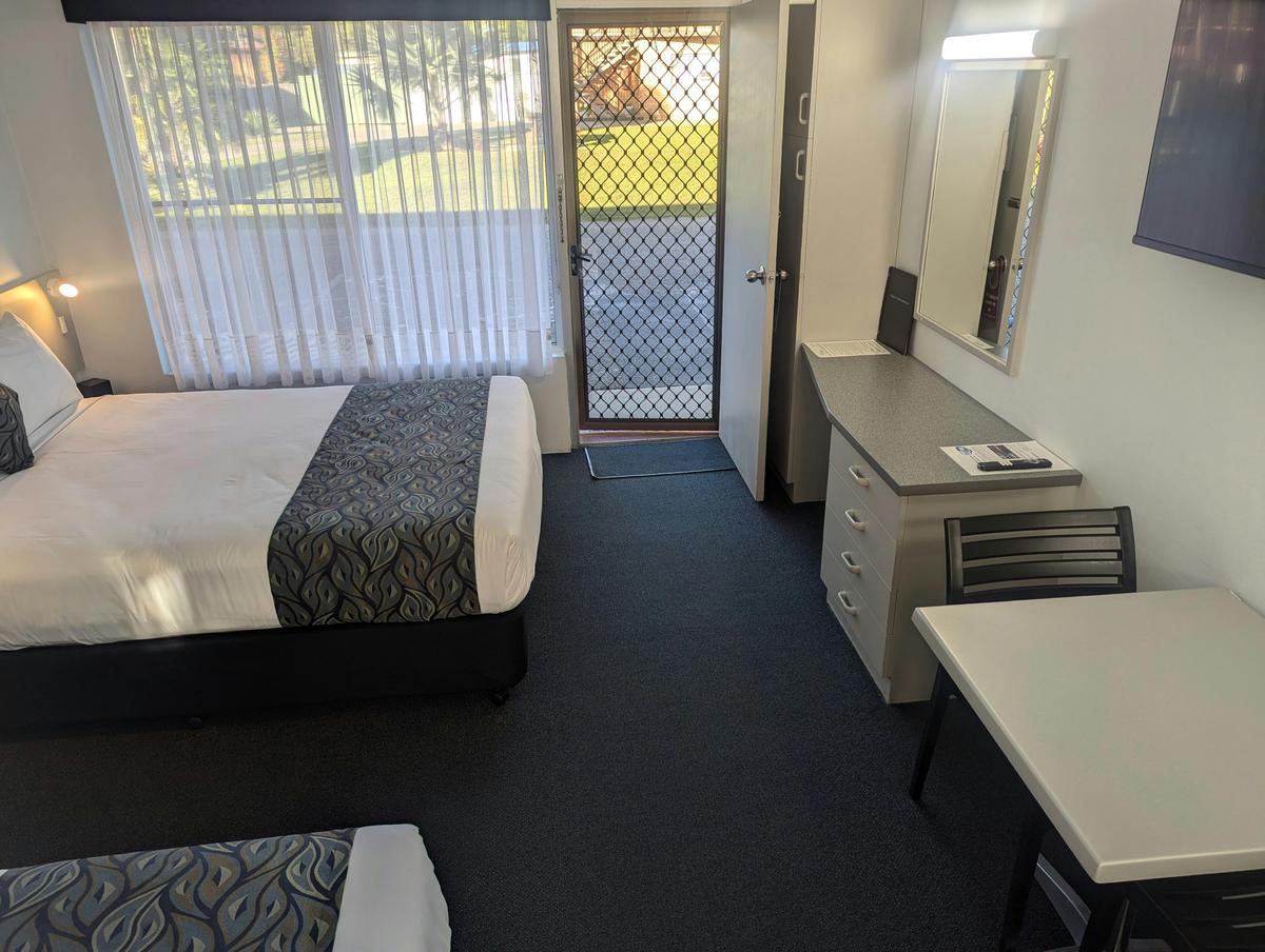 Twin Motel room Queen bed and Single Bed reverse view