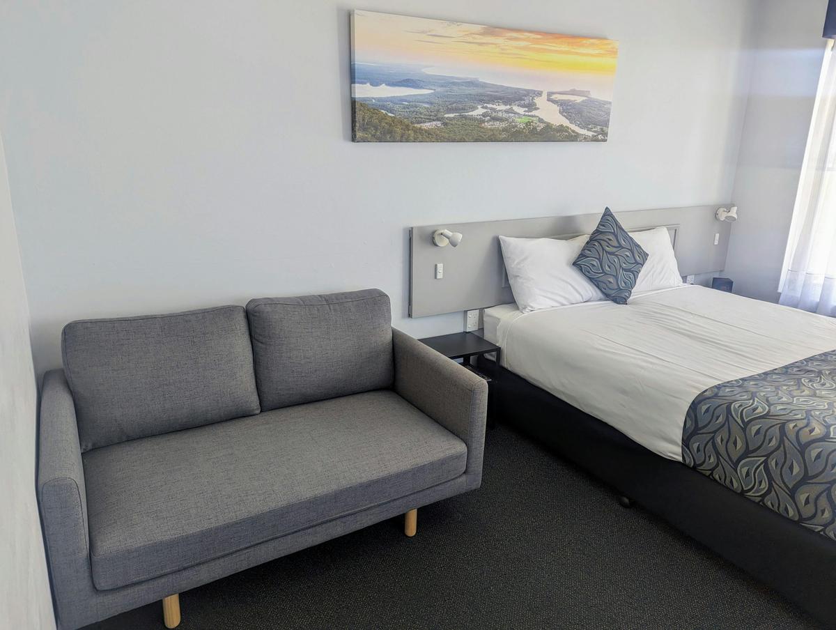 Queen motel room bed and sofa