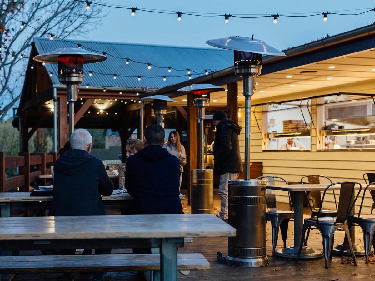 People dining outside in winter at George IV Inn