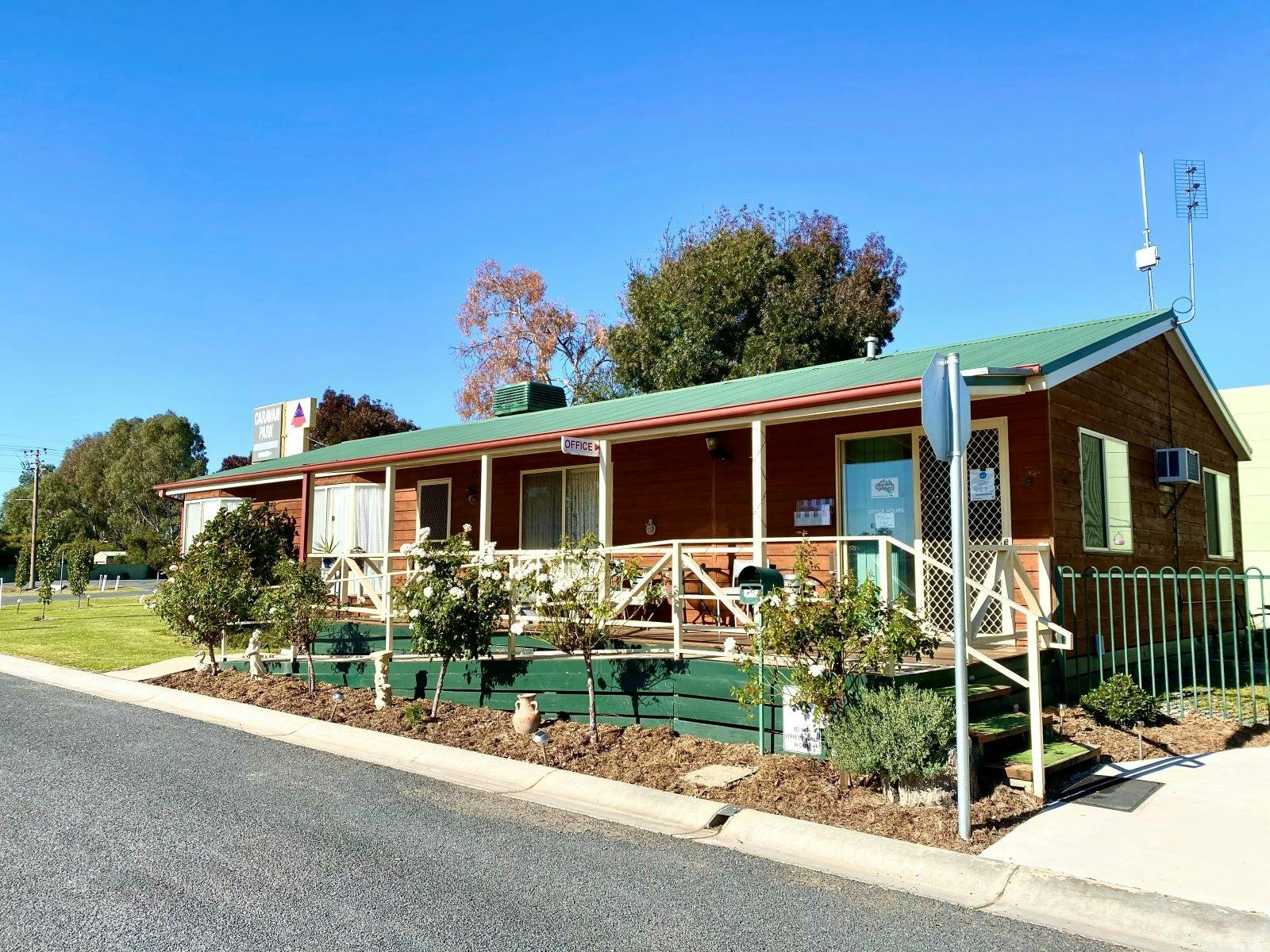 Holbrook Motor Village front reception, brick buildign, green roof and beautiful garden