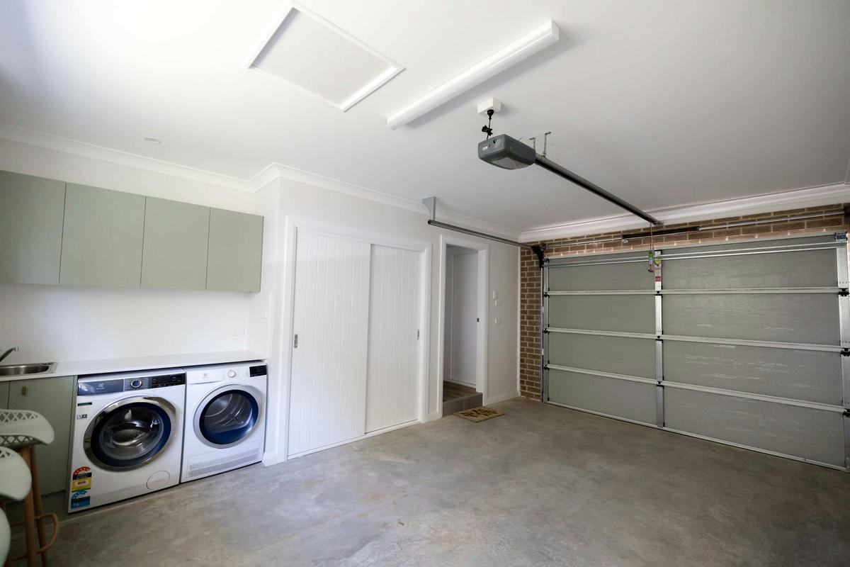 Garage with the laundry at Ideal Family Home