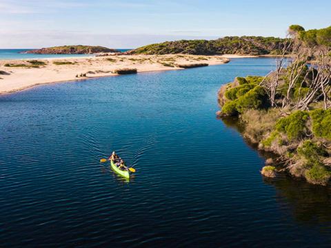 Two people in a canoe on Bournda Lagoon, Bournda National Park. Photo: Daniel Tran/DPIE