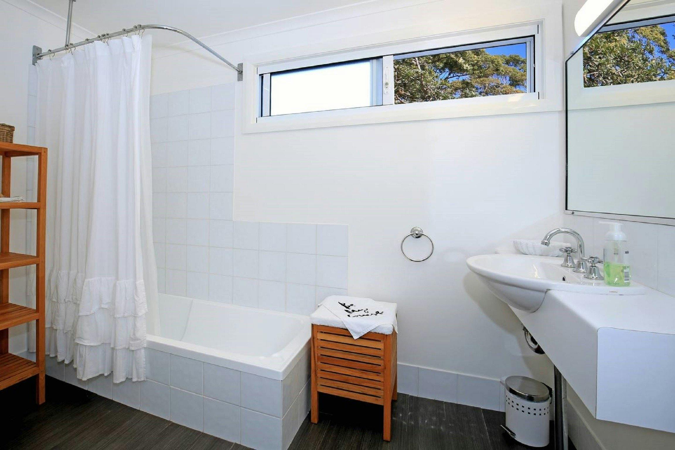 Lovely bright bathroom with bath and shower.
