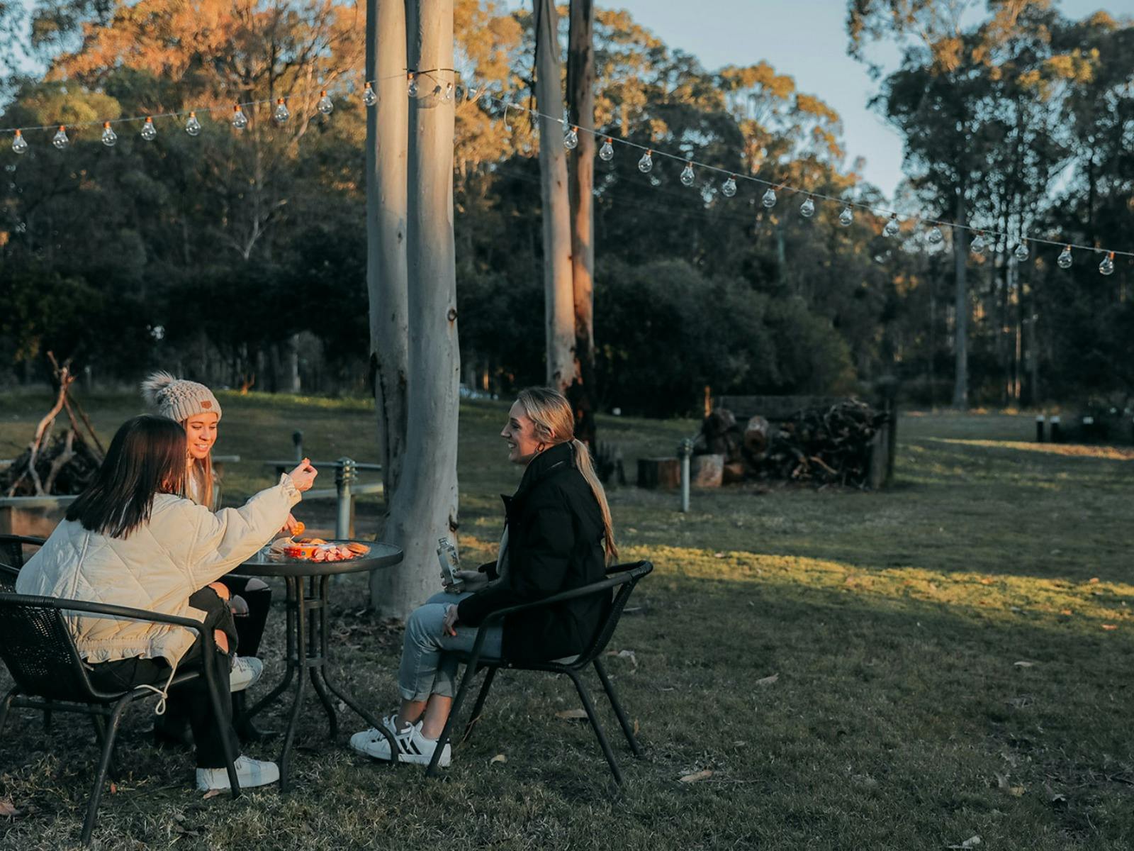 Guests enjoying a cheese board in the grassed common area