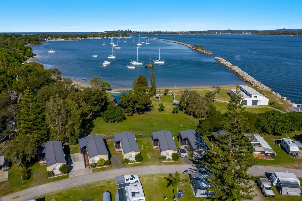 Aerial view of the waterfront cabin overlooking the playground and river