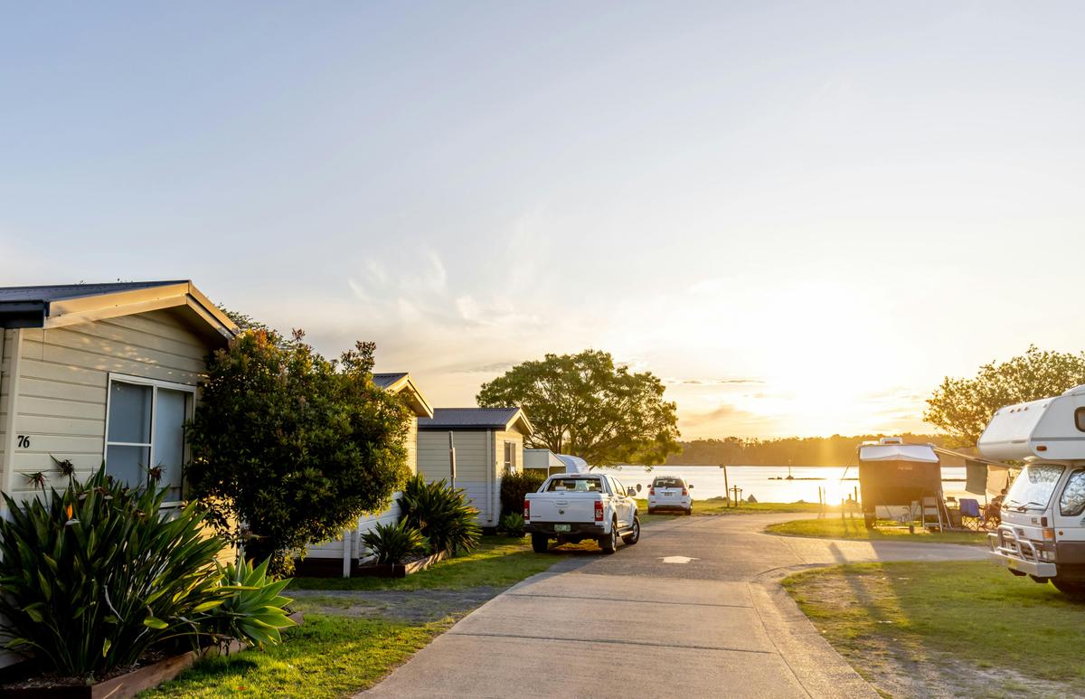 Street view of the Waterfront Cabins with the sun setting over the River