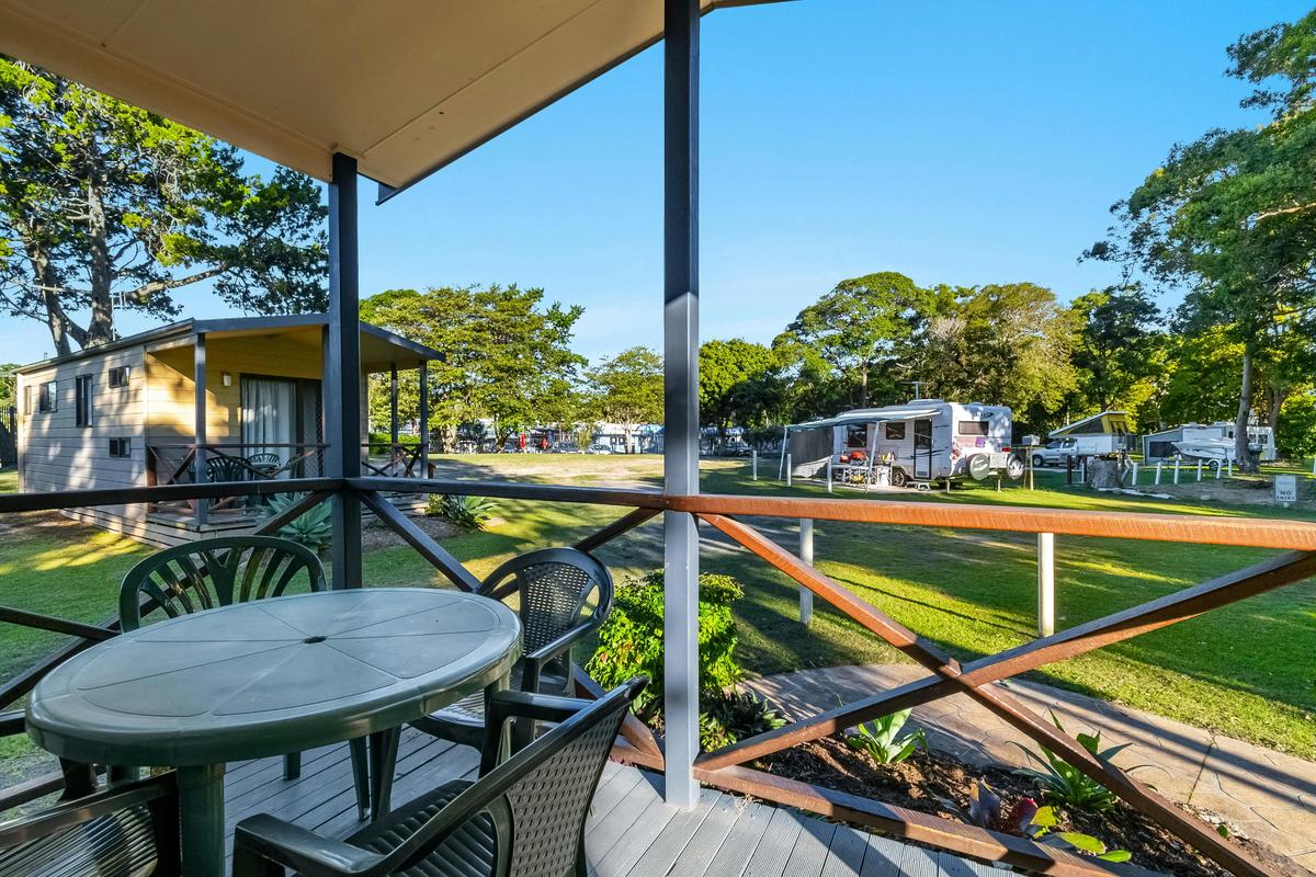 Exterior of park Cabin showing the deck area and surrounding cabins