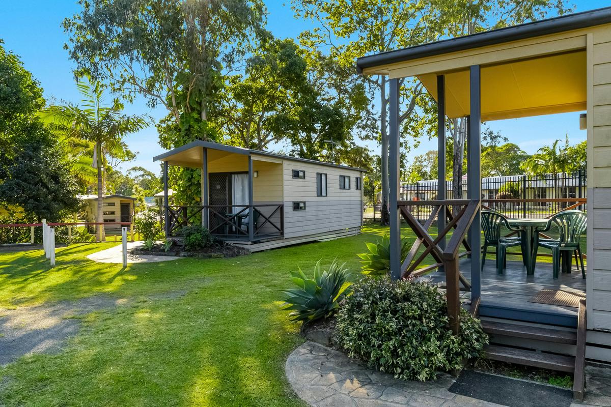 Exterior of park Cabin showing the deck area and surrounding cabins