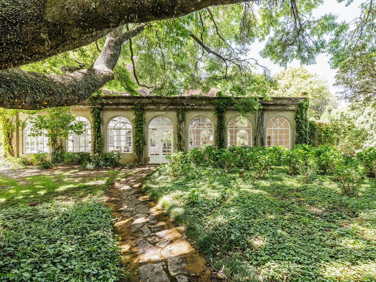 The Milton Park conservatory surrounded by the natural vines of the gardens.