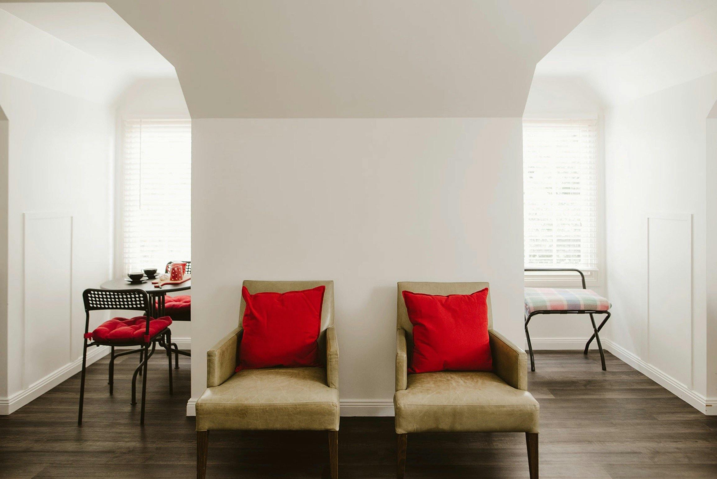 The Loft living area - dining nook, comfy leather chairs and luggage rack with ironing facilities