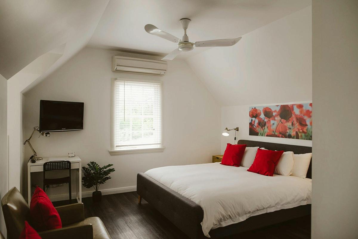 Modern Loft apartment with air conditioning, fan and opening windows looking out on the grounds