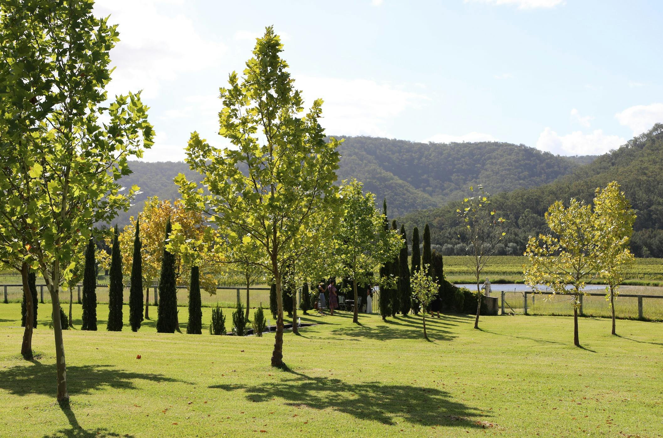 A picturesque landscape of rolling mountains and manicured gardens