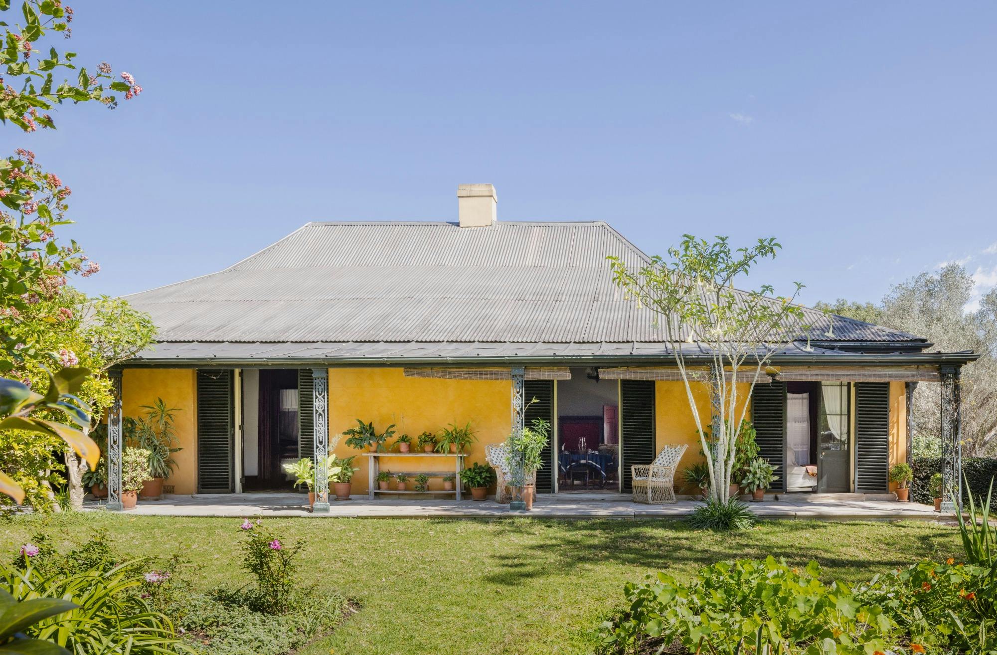 Exterior of historic house with green lawns surrounding