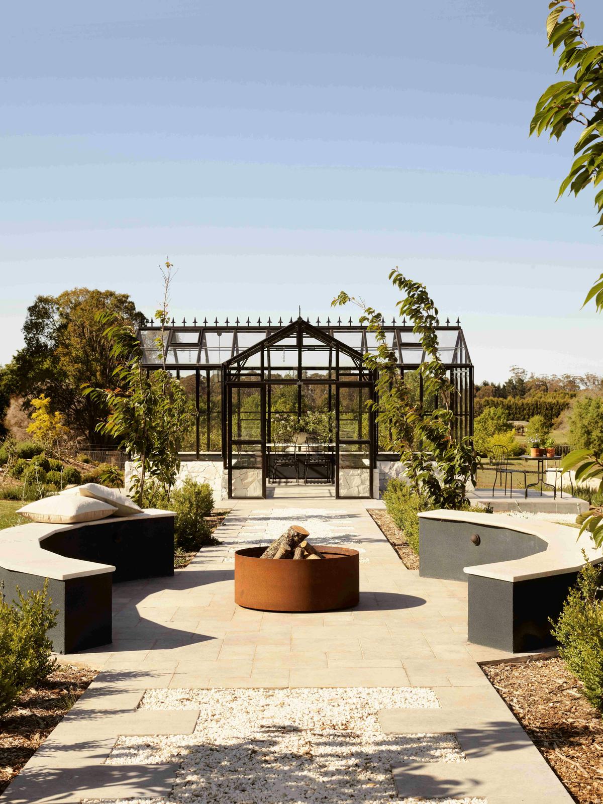 Orangerie for entertaining with a fire pit surrounded by seating.