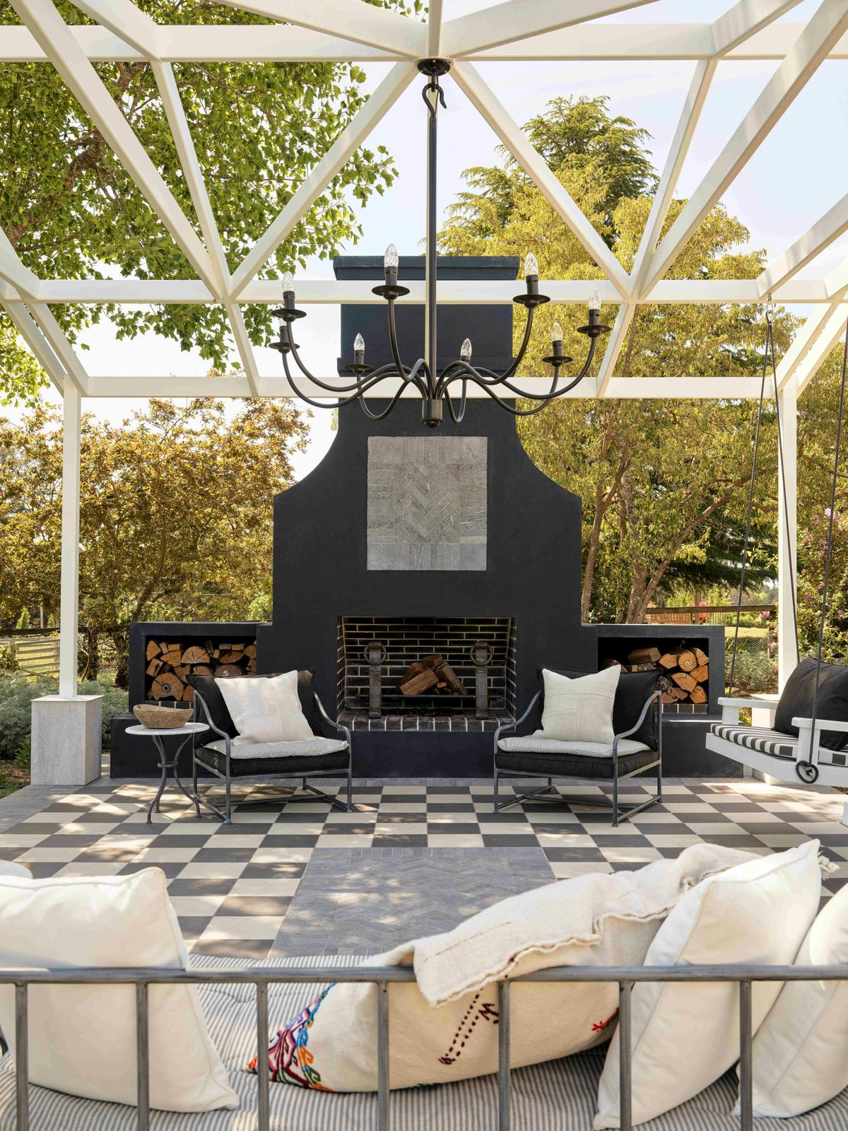 Large exterior fire place and entertaining area, complete with swings to enjoy.