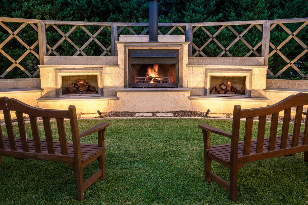 Warm yourself by the outdoor fireplace