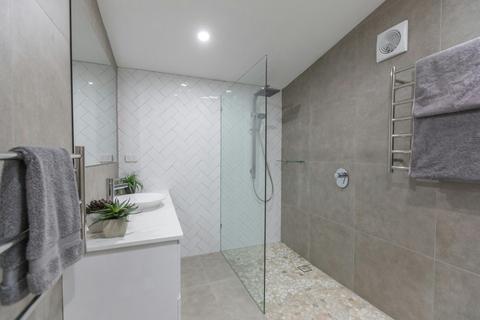 Large bathroom allowing for wheelchair or shower seat